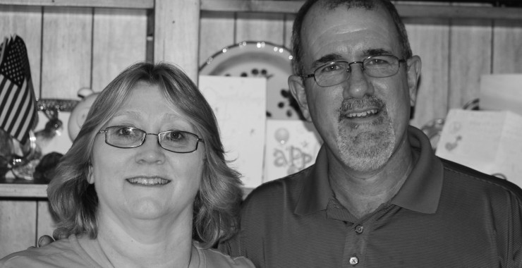 Black and white photo of husband and wife Mentor foster parents from shoulders up